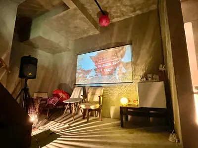 a living room with chairs and a painting on the wall at ICHINAGI Yanaka Luxury Villa near Asakusa in Tokyo
