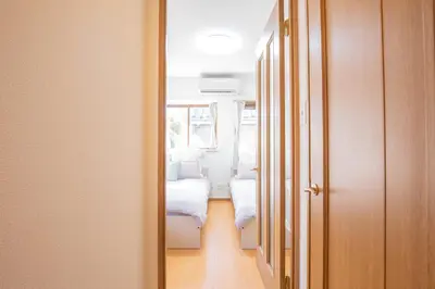 a hallway with two beds in a room at walk to Ushigome-yanagicho sta. EoWh in Tokyo