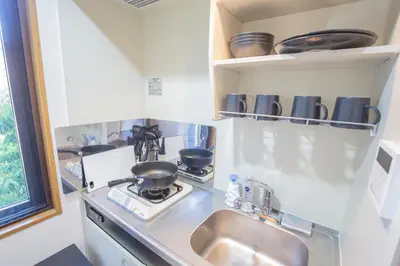 a kitchen counter with a sink and a stove at walk to Ushigome-yanagicho sta. EoWh in Tokyo