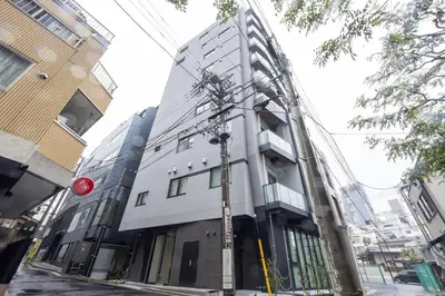 a building on a city street with a pole at Sun Place \u795e\u697d\u5742 in Tokyo
