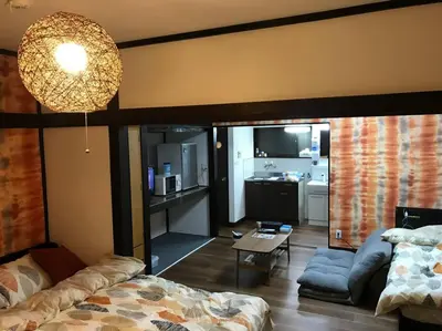 a living room with a couch and a table at RIKASOU#101 in Tokyo