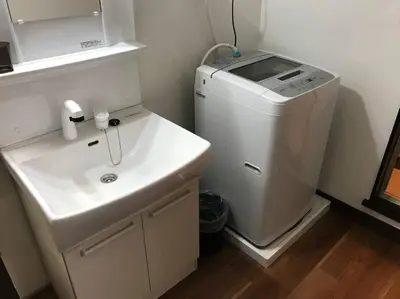 a bathroom with a sink and a washing machine at RIKASOU#101 in Tokyo
