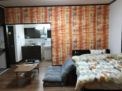 a living room with a bed and a table at RIKASOU#101 in Tokyo