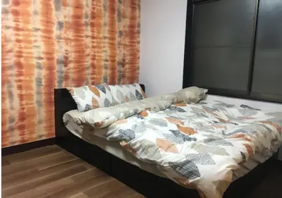 a bed with a comforter on it in a room at RIKASOU#101 in Tokyo