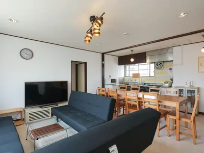 a living room with a couch and a dining room at Grace Mukojima 701 in Tokyo