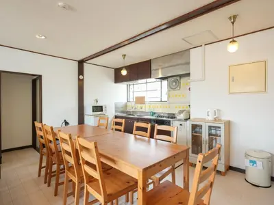 a large kitchen with a wooden table and chairs at Grace Mukojima 701 in Tokyo