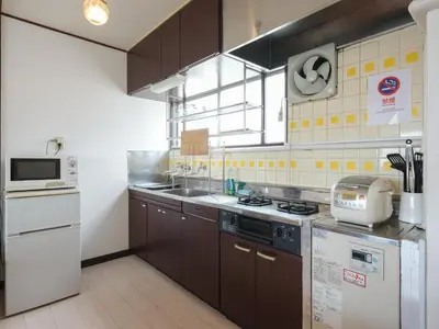 a kitchen with a sink and a stove top oven at Grace Mukojima 701 in Tokyo