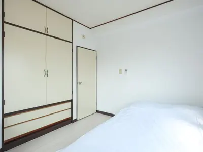 a bedroom with white cabinets and a bed at Grace Mukojima 701 in Tokyo