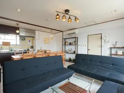 a living room with blue couches and a table at Grace Mukojima 701 in Tokyo