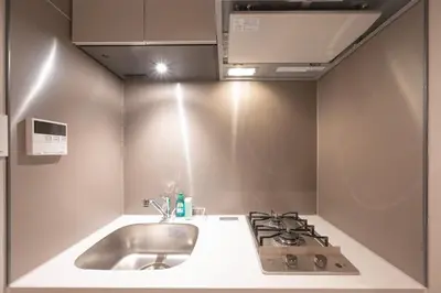 a kitchen with a sink and a stove at CREAL premier\u5927\u68ee\u5317 in Tokyo