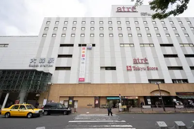a building with cars parked in front of it at CREAL premier\u5927\u68ee\u5317 in Tokyo