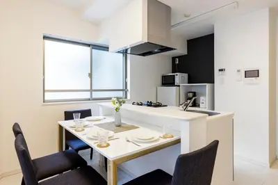 a kitchen and dining room with a table and chairs at Live Casa Tokyo\u6d5c\u677e\u753a - Direct Haneda Monorail - Near Tokyo Tower - 1 Stop to Shinkansen in Tokyo