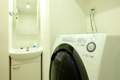a washing machine in a bathroom with a sink at Live Casa Tokyo\u6d5c\u677e\u753a - Direct Haneda Monorail - Near Tokyo Tower - 1 Stop to Shinkansen in Tokyo