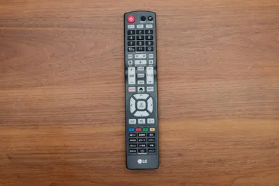 a remote control sitting on top of a wooden table at Live Casa Tokyo\u6d5c\u677e\u753a - Direct Haneda Monorail - Near Tokyo Tower - 1 Stop to Shinkansen in Tokyo