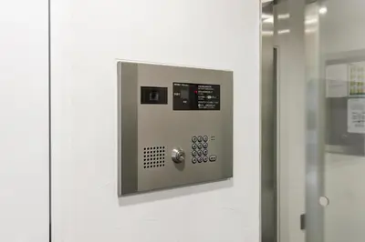 a door with a control panel on a wall at Live Casa Tokyo\u6d5c\u677e\u753a - Direct Haneda Monorail - Near Tokyo Tower - 1 Stop to Shinkansen in Tokyo