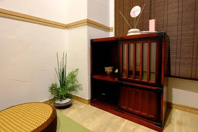 a room with a wooden cabinet with a potted plant at Shinbashi Residence - Near Ginza & Food Scene - Direct HND,NRT 東京新橋579 in Tokyo