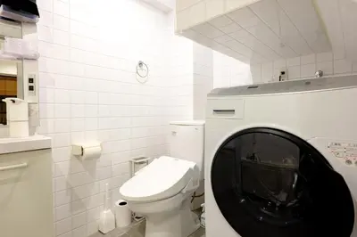 a washing machine in a bathroom with a toilet at Shinbashi Residence - Near Ginza & Food Scene - Direct HND,NRT 東京新橋579 in Tokyo