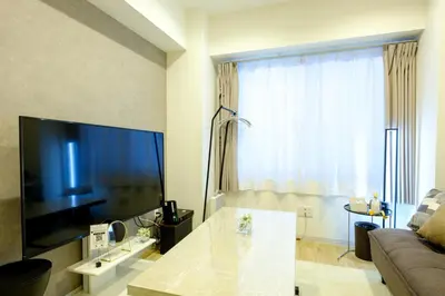 a living room with a couch and a large window at Shinbashi Residence - Near Ginza & Food Scene - Direct HND,NRT 東京新橋579 in Tokyo