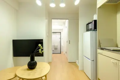 a kitchen with a table and a vase on a table at Modern Meguro Apt - 2 Mins Walk - Direct to Shibuya,Ebisu,Haneda - \u9577\u8005\u4e38\u30d3\u30eb in Tokyo