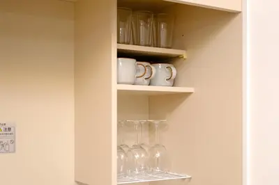 a shelf with wine glasses and mugs on it at Modern Meguro Apt - 2 Mins Walk - Direct to Shibuya,Ebisu,Haneda - \u9577\u8005\u4e38\u30d3\u30eb in Tokyo
