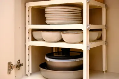 a shelf with bowls and plates in a kitchen at Modern Meguro Apt - 2 Mins Walk - Direct to Shibuya,Ebisu,Haneda - \u9577\u8005\u4e38\u30d3\u30eb in Tokyo