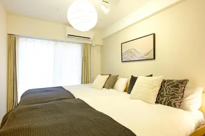 a large bed in a room with a window at Modern Meguro Apt - 2 Mins Walk - Direct to Shibuya,Ebisu,Haneda - \u9577\u8005\u4e38\u30d3\u30eb in Tokyo