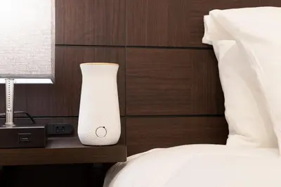 a white vase sitting on a night stand next to a bed at Bijou Suites Cocoa in Tokyo