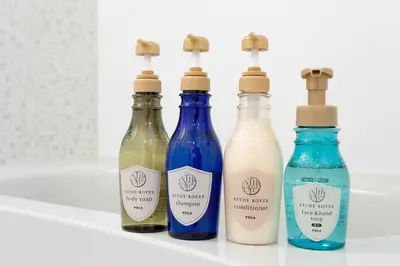 a group of four bottles sitting on a shelf at Bijou Suites Cocoa in Tokyo