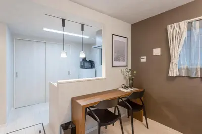 a dining room with a table and two chairs at Bijou Suites Cocoa in Tokyo