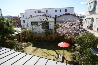 a red umbrella in a yard with a house at 東京寓 - Spacious Traditional Home & Zen Garden - For Family&Group up to 8 ppl in Tokyo