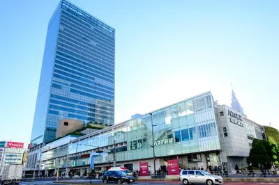 a large glass building with cars parked in front of it at Nishi-Shinjuku Residence - 2F House - Quiet Area Walkable to Shinjuku Station - Ciel\u897f\u65b0\u5bbf in Tokyo