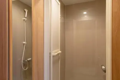 a bathroom with a shower and a glass door at Shinjuku Zen House 1F 70sqm Spacious Townhouse No Stairs R1 in Tokyo