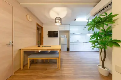 a dining room with a table and a potted plant at Shinjuku Zen House 1F 70sqm Spacious Townhouse No Stairs R1 in Tokyo