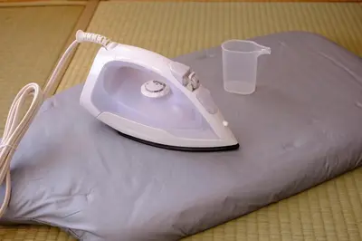 a white iron sitting on top of a pillow with a glass at Board Game House Tokyo - Authentic Old Tokyo - 3 BR House - 15mins to Asakusa, Skytree in Tokyo
