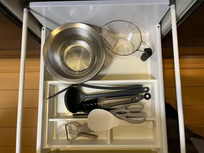 a drawer full of kitchen utensils in a refrigerator at Saitore in Tokyo