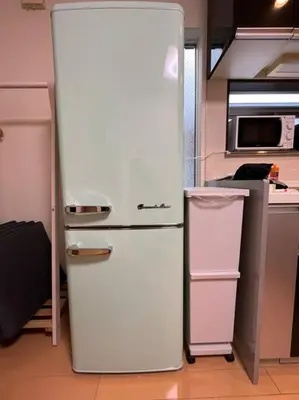 a white refrigerator in a kitchen next to a microwave at Saitore in Tokyo