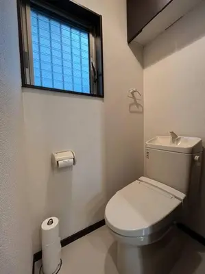 a bathroom with a white toilet and a window at Saitore in Tokyo