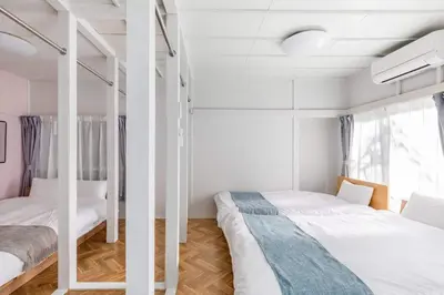two beds in a room with white walls at AKEBONOBASHI Detached house HA1 in Tokyo