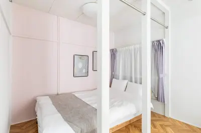 a white bedroom with a bed and a window at AKEBONOBASHI Detached house HA1 in Tokyo