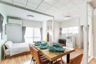 a dining room with a table with blue dishes on it at AKEBONOBASHI Detached house HA1 in Tokyo
