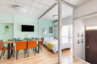 a bedroom with a bed and a table and chairs at AKEBONOBASHI Detached house HA1 in Tokyo