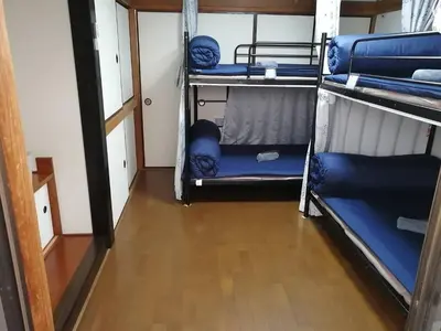 a room with three bunk beds and a wooden floor at \u30b2\u30b9\u30c8\u30cf\u30a6\u30b9\u6804 in Tokyo