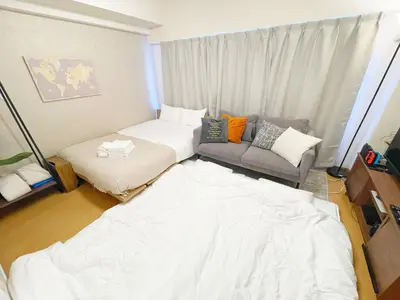 a small room with a bed and a couch at LVB Shinjuku in Tokyo