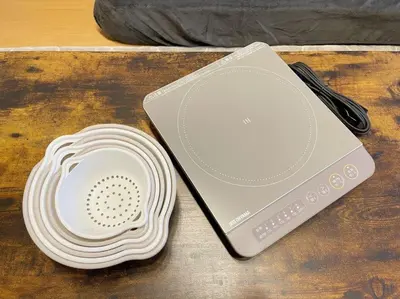 a stack of plates sitting on a table next to a scale at LVB Shinjuku in Tokyo