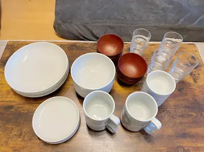 a group of bowls and cups on a wooden table at LVB Shinjuku in Tokyo