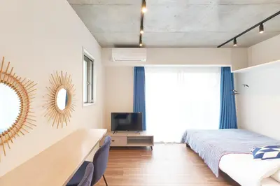 a bedroom with a bed and a tv and a mirror at MATSUMIZAKA Hill by Tranova in Tokyo
