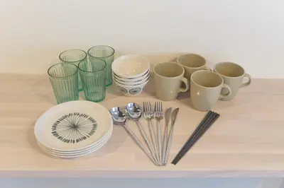 a shelf with a bunch of cups and plates and spoons at MATSUMIZAKA Hill by Tranova in Tokyo