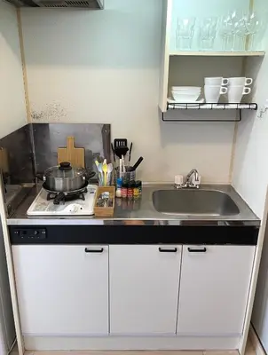 a small kitchen with a sink and a stove at Near\u65b0\u5bbf Safy Room in Tokyo