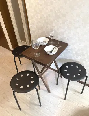 a wooden table and two chairs with wine glasses at Near\u65b0\u5bbf Safy Room in Tokyo
