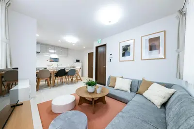 a living room with a blue couch and a table at HOTEL Peerson - Vacation STAY 73421v in Tokyo